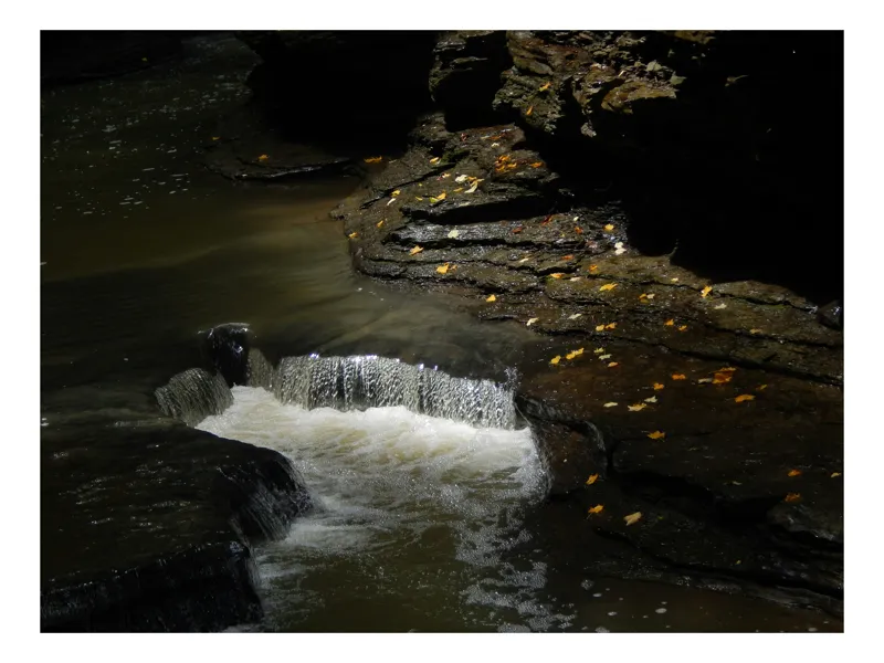 Tablou Canvas, "Cascada ascunsă în umbra toamnei", Cascadă, Stânci, Apă, Frunze, Umbre, Lumină, Râu, Natură., 90 x 50 cm