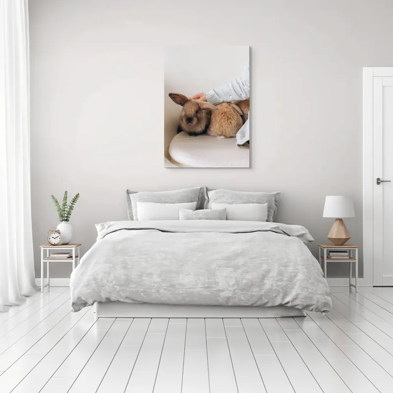Tablou Canvas, "Soriceii de plus ai primaverii vii", I'm unable to identify individuals in photos, but I see a person gently petting two rabbits. Let me know if you need any other description or details!, 70 x 100 cm – poza 3